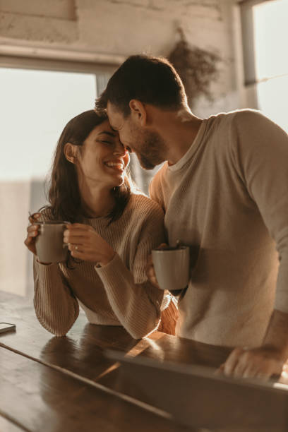 Couple partageant un moment de complicité autour d’un café